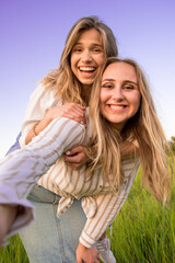 Girlfriends take selfies and shoot their summer video blog. They play in nature