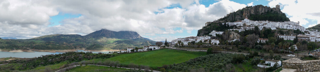 panorama view of the whitwashed Andalusian village of Zahara de la Sierra and its Moorish Castle on the hilltop