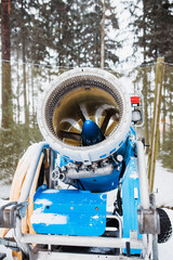 Blue powerful snow cannon in the mountains to create artificial snow for mountain skis