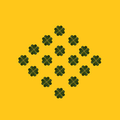 Naklejka premium Pattern created of minimal lucky shamrock arranged from hearts formed of fresh green leaves from Irish woods. Clovers shape leaves are against yellow background from flat lay.