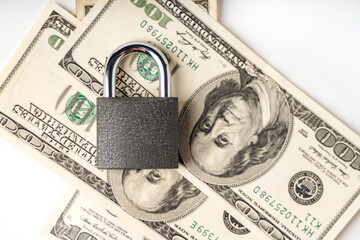 Locked lock on banknotes as a concept of financial security of deposits and money storage