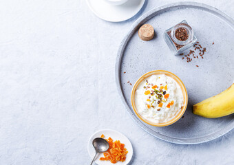 Healthy breakfast with cottage cheese and banana, flaxseed and seasonal fruits.