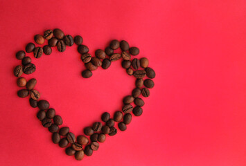 heart of coffee beans on a pink background