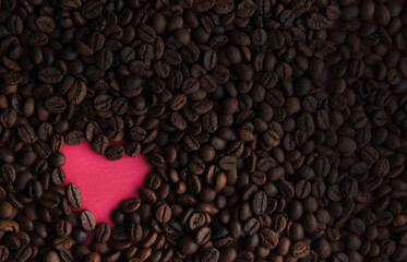 pink heart on the background of coffee beans