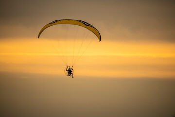 paraglider silhouette at sunset