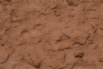 Fototapeta na wymiar Wall of soil house. texture of clay house structure. Mud background, selective focus. soft picture