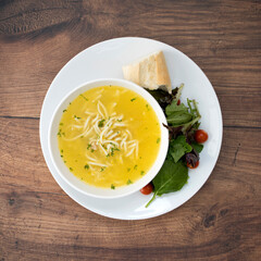 Bowl of Chicken Noodle Soup on a Wooden Table