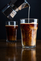 iced coffee over ice cubes with milk