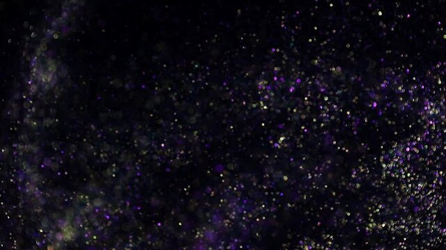 Decoration bokeh glitters background video. Abstract blurred backdrop with circles in motion. Footage with liquid shining particles. Colorful and vivid fluent animation with blur effect