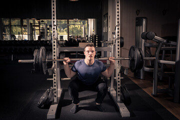 Fototapeta na wymiar man lifting heavy weights in a gym