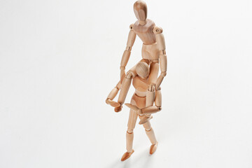 a wooden mannequin sitting on one another mannequin's neck