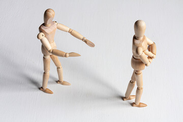 one wooden mannequin trying to make it up with another one