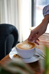 person with cup of latte