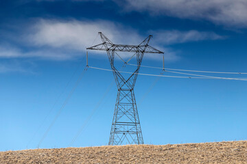 High voltage electric pole and transmission lines. High voltage grid tower with wire cable at...