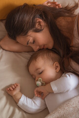 Mother and her baby sleeping together happy 