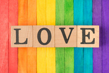 Close up photo image of wooden blocks with love text isolated multicolored desk