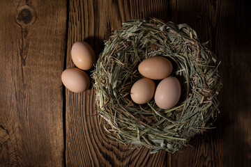 Easter eggs in a basket on a vintage wooden background. eggs in the nest with copy space