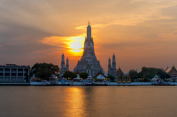 Fototapeta na wymiar Wat Arun Ratchawararam Ratchawaramahawihan or Wat Arun meaning Temple of Dawn on Chao Phraya River at sunset , Bangkok , Thailand