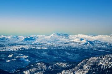 Snowy mountains in the Norwegian wilderness on a cold clear winter evening.