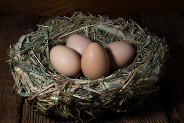 Easter eggs in a basket on a vintage wooden background. eggs in the nest with copy space