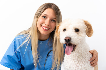 Young veterinarian woman with dog sitting on the floor
