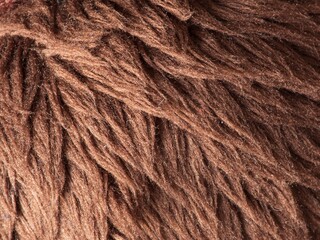 The texture of a brown plush toy is close-up. Details.