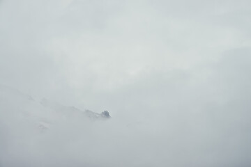 Minimal mountain landscape with high pointy rock in clouds. Minimalist mountain scenery with sharp...