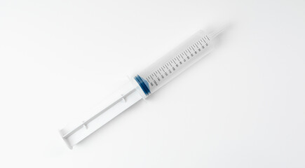 Large open syringe on white background. Syringe with scale. Vaccine and medicine concept.