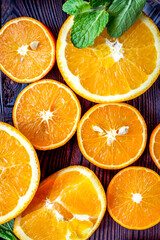 orange juice with mint squeezing on wooden kitchen background top view