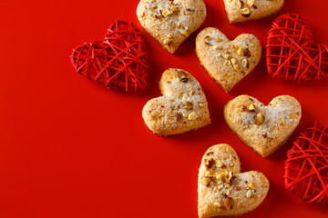 Fototapeta na wymiar Heart shaped sugar cookies on red background