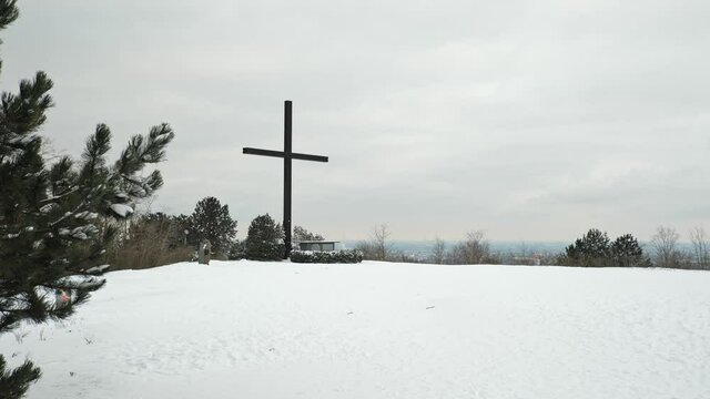 [4k] christian cross ontop of snowy mountain at halde haniel