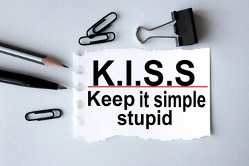 KISS, keep it simple, stupid. text on white paper on gray background