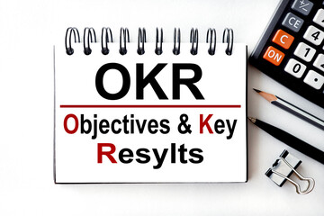 writing text and acronym of OKR .Objective Key Results. on white background