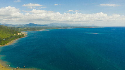 Fototapeta na wymiar Aerial view of the coast of a tropical island with a beach and blue sea. Philippines, Mindanao.
