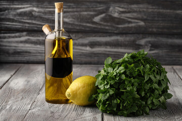 Olive oil, balsamic vinegar, lemon and green basil, a set of products for making simple and delicious salad dressings and sauces.
