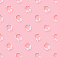 Pink headphones on a pink background. Pattern. Concept for music, podcasts, audiobooks. Top view,...