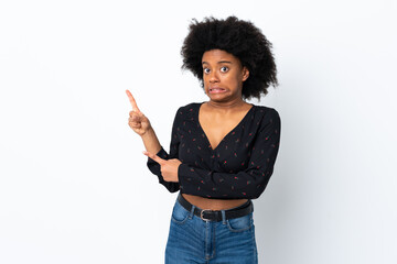 Young African American woman isolated on white background frightened and pointing to the side