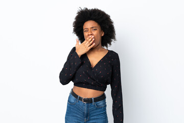 Fototapeta na wymiar Young African American woman isolated on white background yawning and covering wide open mouth with hand