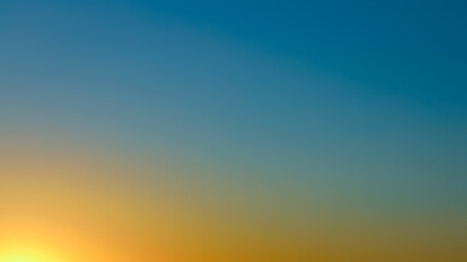 Sunset sky background captured in the evening, sky atmosphere in natural colors with gradient, sky defocused texture without clouds