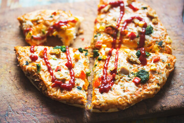 Pizza with chicken, spinach, mushrooms and corn with ketchup