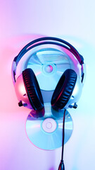 Fototapeta na wymiar headphones and a CD . red and blue illumination, cyberpunk.