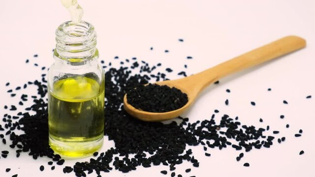 essential oil of black cumin in small bottles. selective focus.