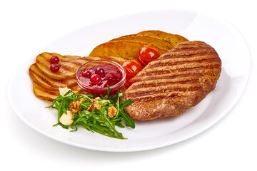 Grilled beef steak with potato wedges, grilled pears and arugula salad with feta cheese, isolated on white background