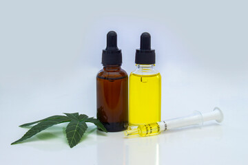 A Couple of Cannabis Dropper Bottles with a cannabis flower and a cannabis leaf next