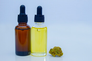 A Couple of Cannabis Dropper Bottles with a cannabis flower. Portable Oil Glass Bottle, Cannabis Oil Bottle.