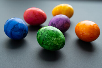 Easter eggs in a modern, colorful pattern on a black background. Selective focus.