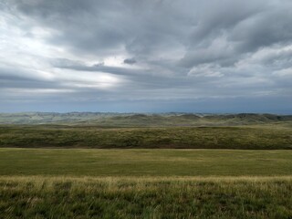Wide green landscape view with clouds