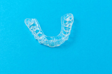 Plastic cap for teeth on a blue background