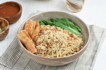 Cwie Mie is authentic noodles dish from Malang, Indonesia. Noodle served with minced chicken, fried shallot and fried dumpling or cracker
