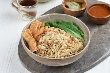 Cwie Mie is authentic noodles dish from Malang, Indonesia. Noodle served with minced chicken, fried shallot and fried dumpling or cracker